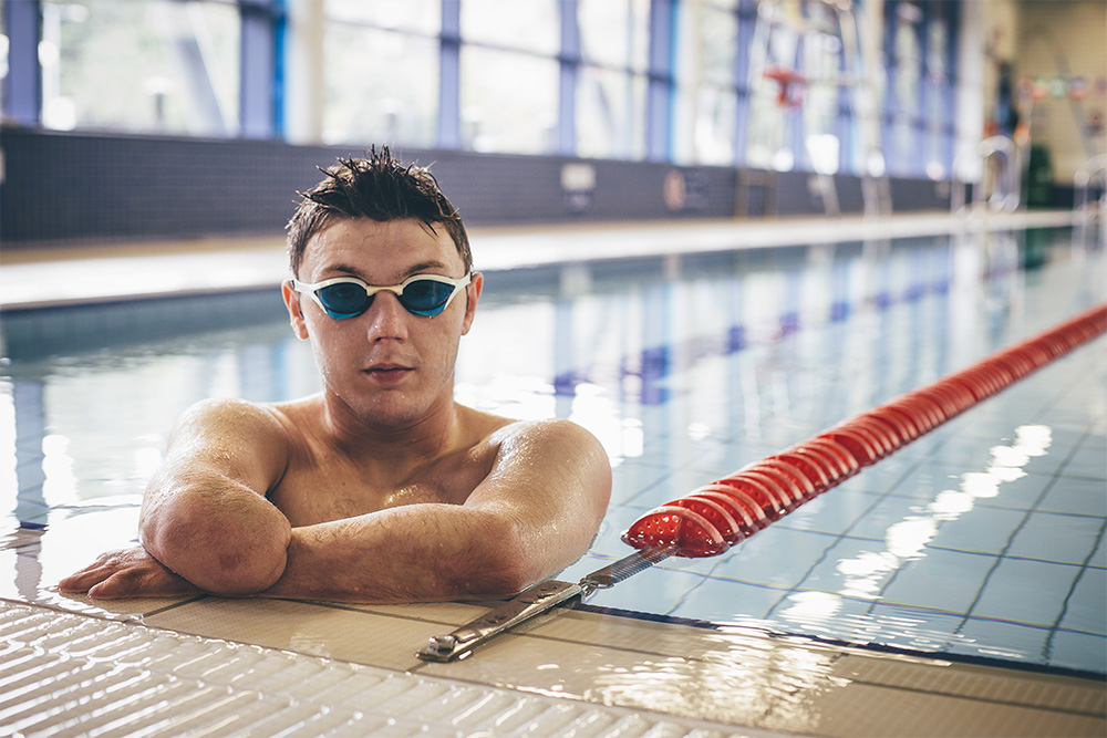 It is a man swimming missing an arm.
